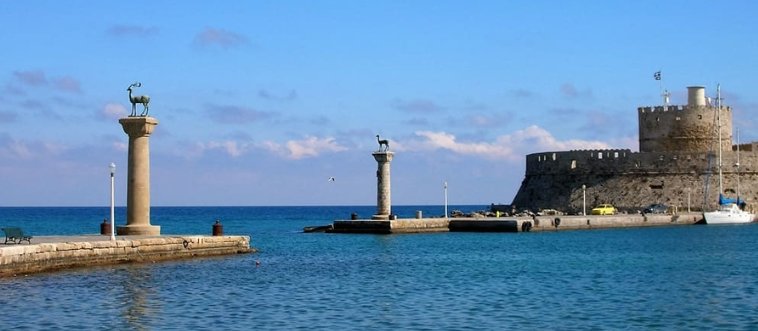 Drop anchor and savor this legendary memory: which ancient wonder was a monumental statue towering over a Greek port?